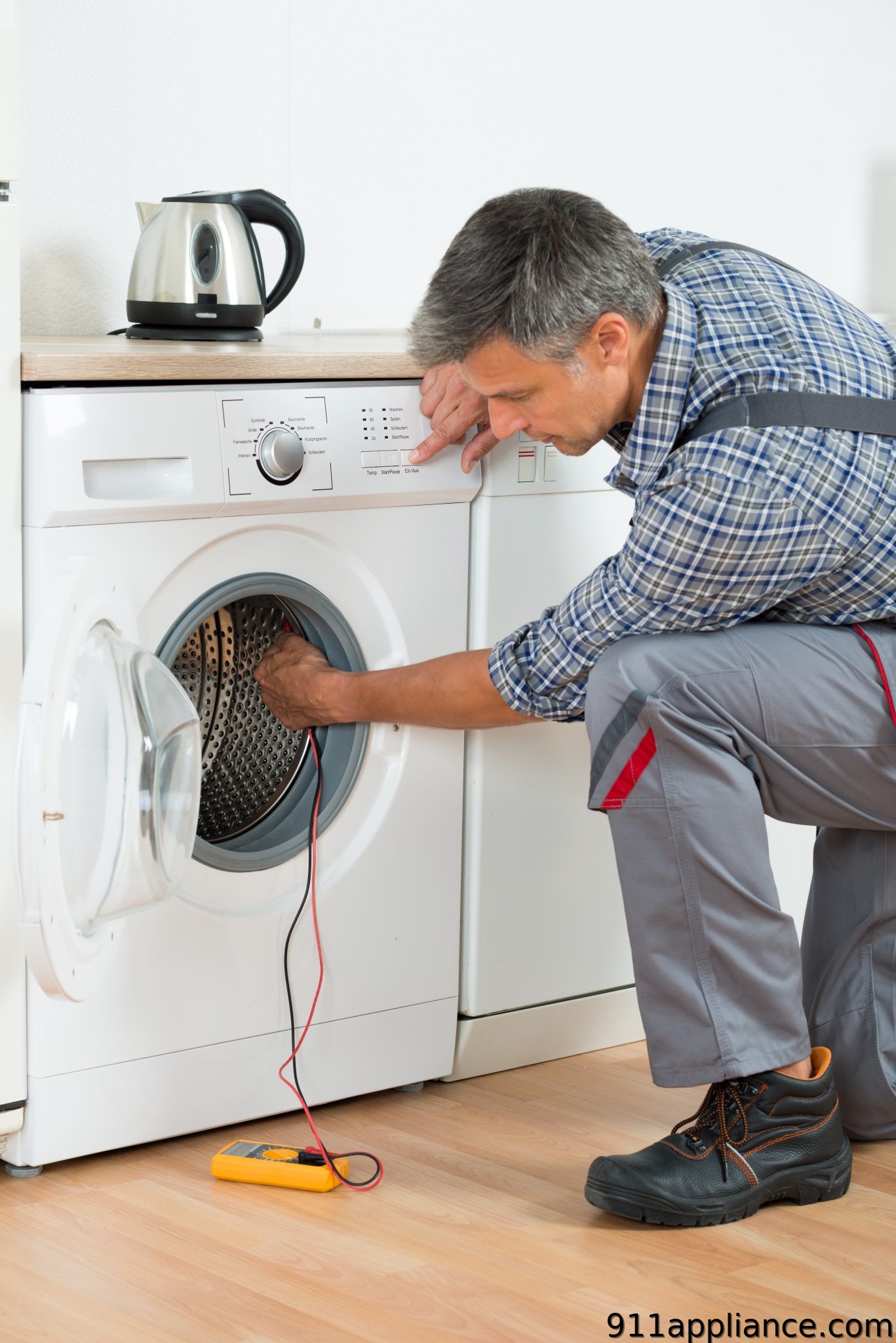 Washer repair technician testing appliance