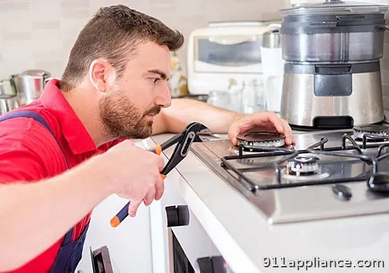 Technician repairs gas stove