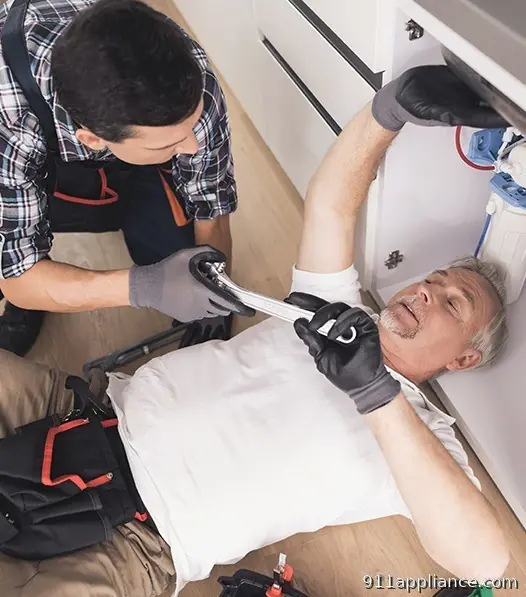 Plumbers fixing sink pipes