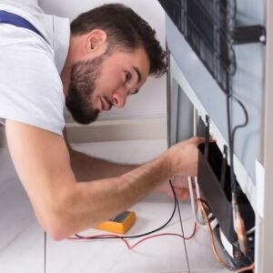 Technician repairs refrigerator coils