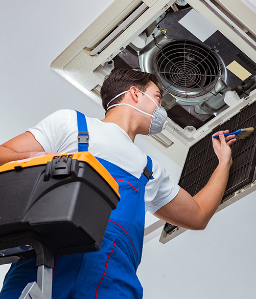 a man working on an air conditioning unit.
