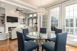 a dining room with a glass table and chairs.