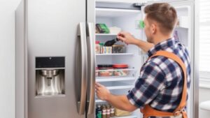 Technician repairing a refrigerator