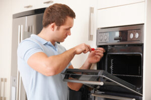 a man opening an oven.
