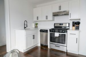 Modern white kitchen with stainless steel appliances