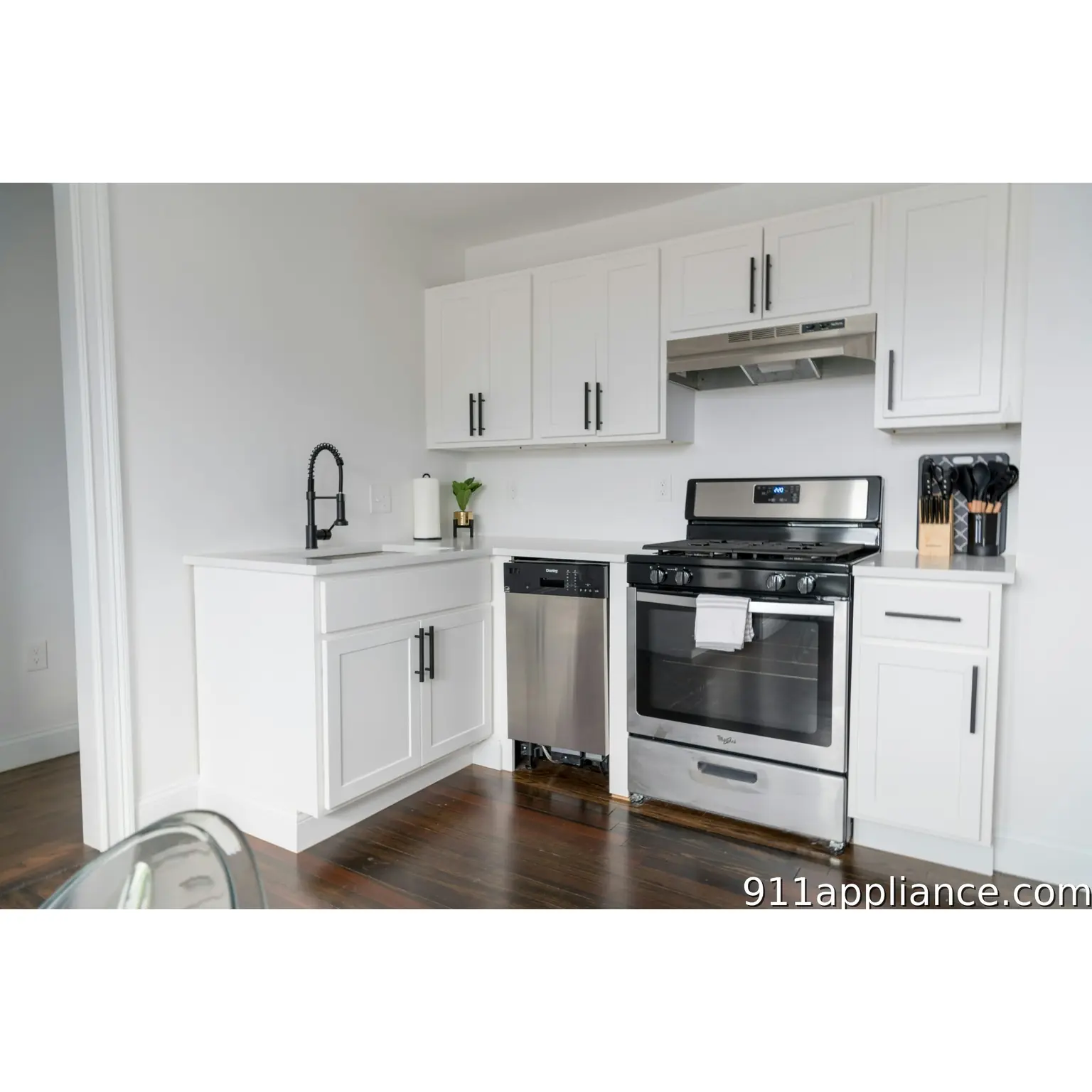 Modern white kitchen with stainless steel appliances