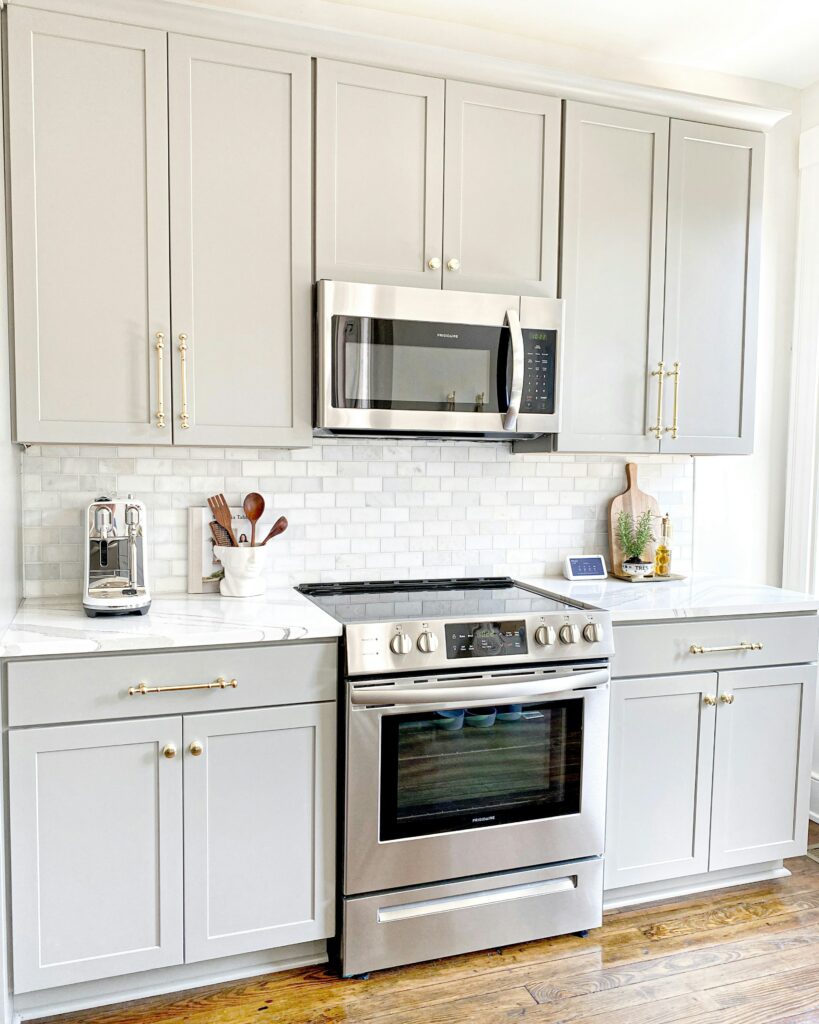 a kitchen with grey cabinets and a microwave.