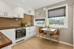 A small kitchen with a table and chairs.