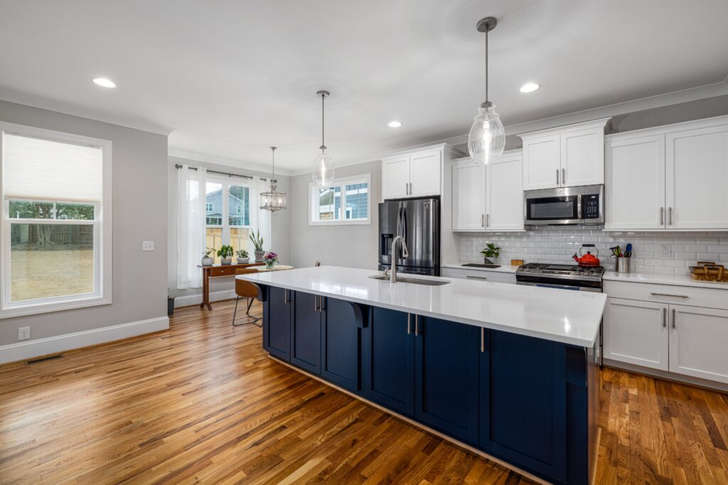 A kitchen with white cabinets and blue counter tops.