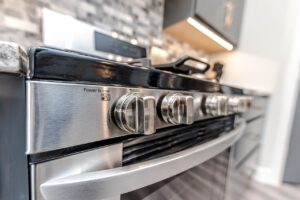 A stainless steel stove top in a kitchen.