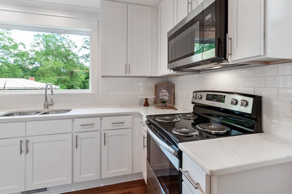 A white kitchen with a stove and oven.