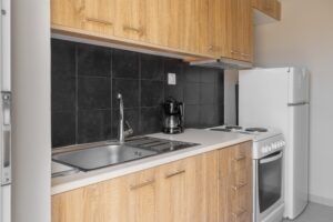 A small kitchen with wooden cabinets and a microwave.