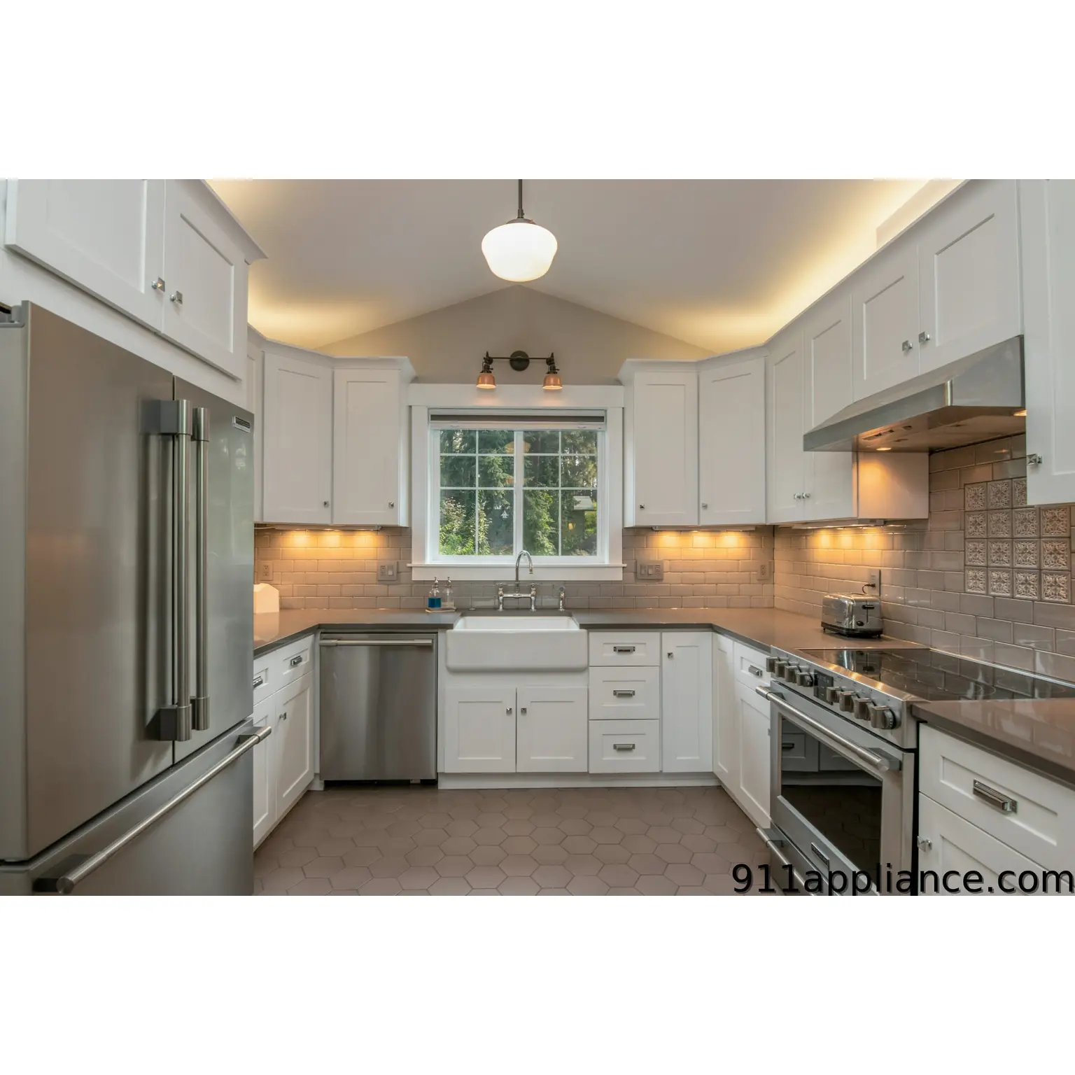 Modern white kitchen with stainless steel appliances