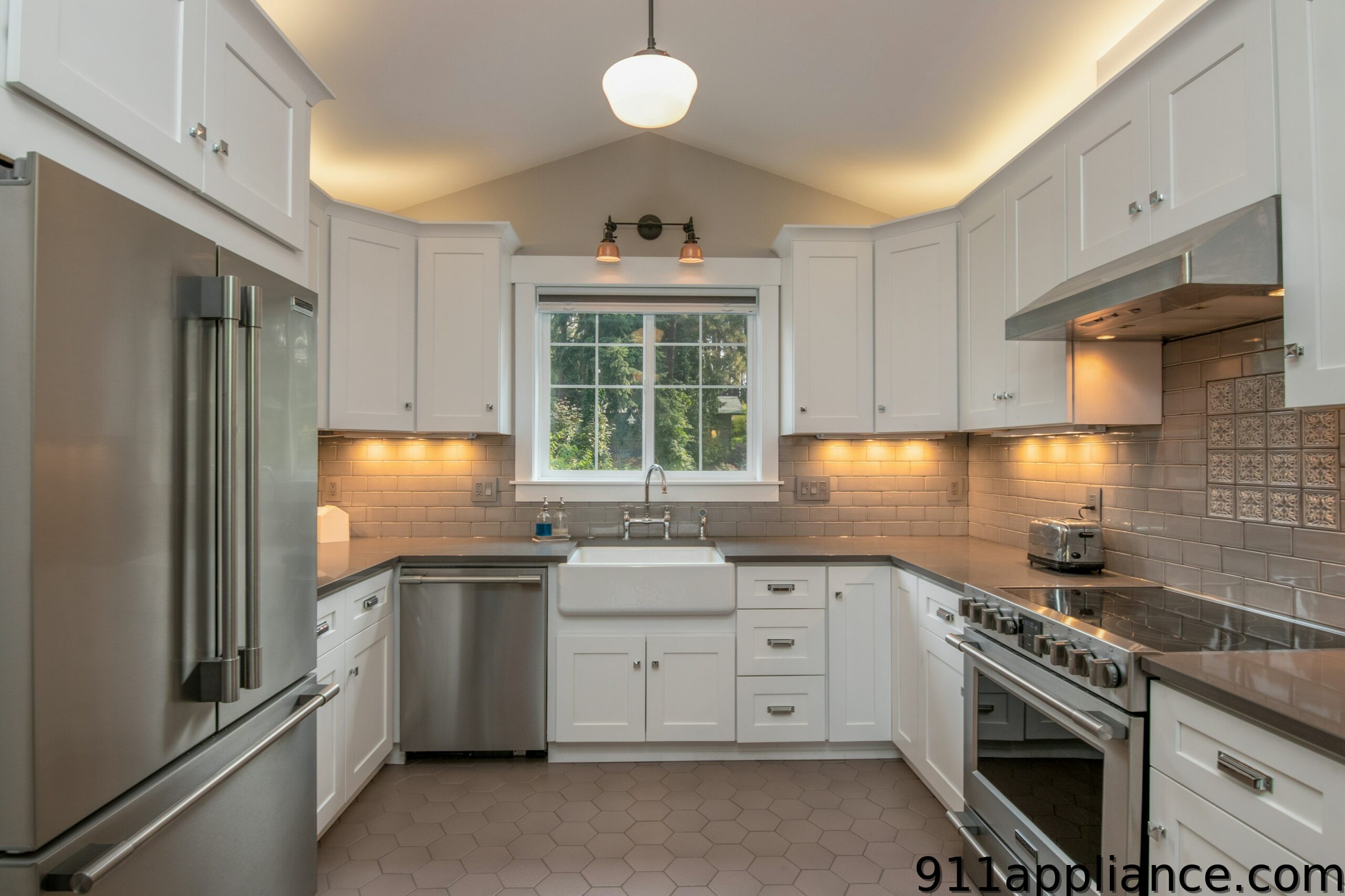 Modern white kitchen with stainless steel appliances