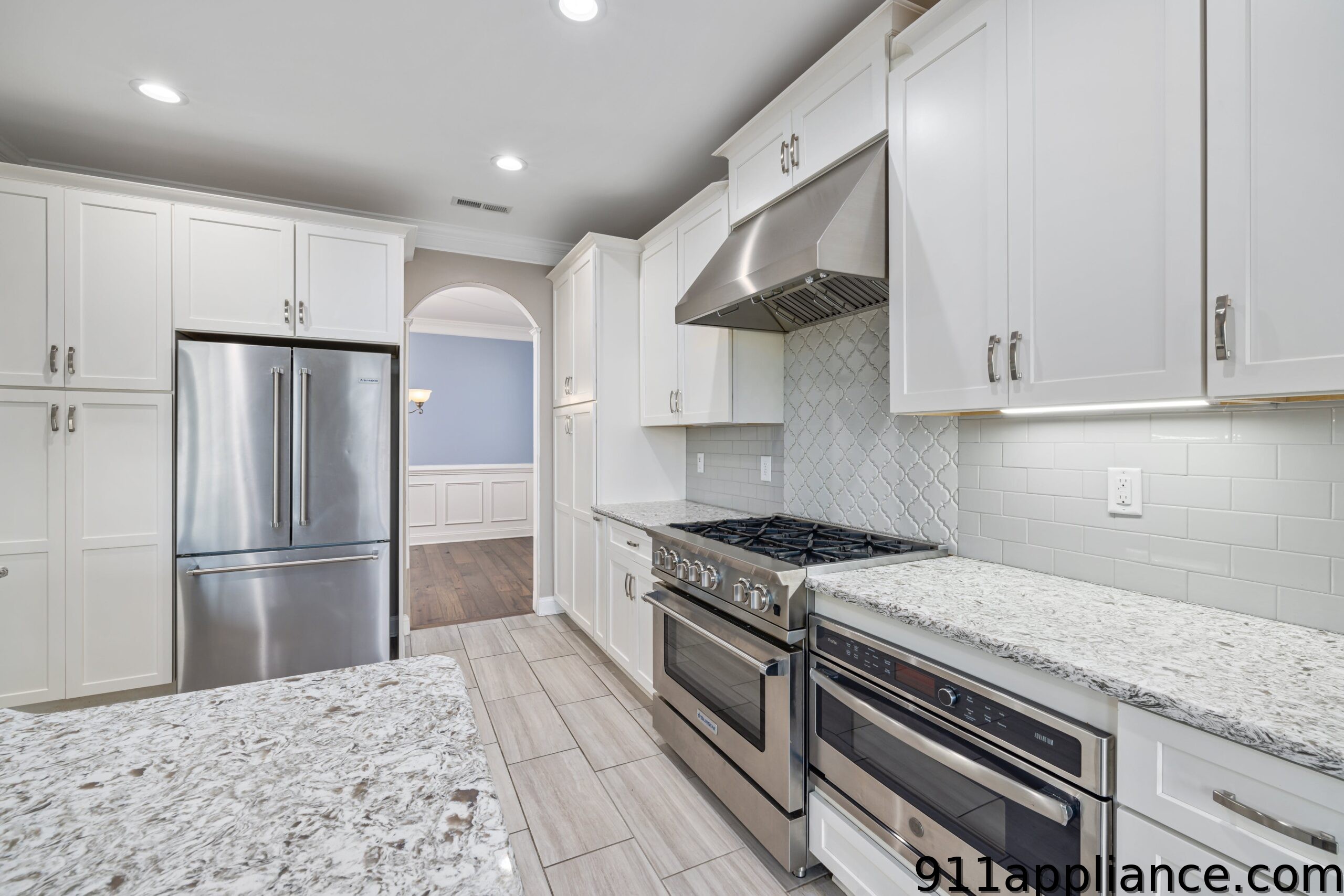 Modern white kitchen with stainless steel appliances