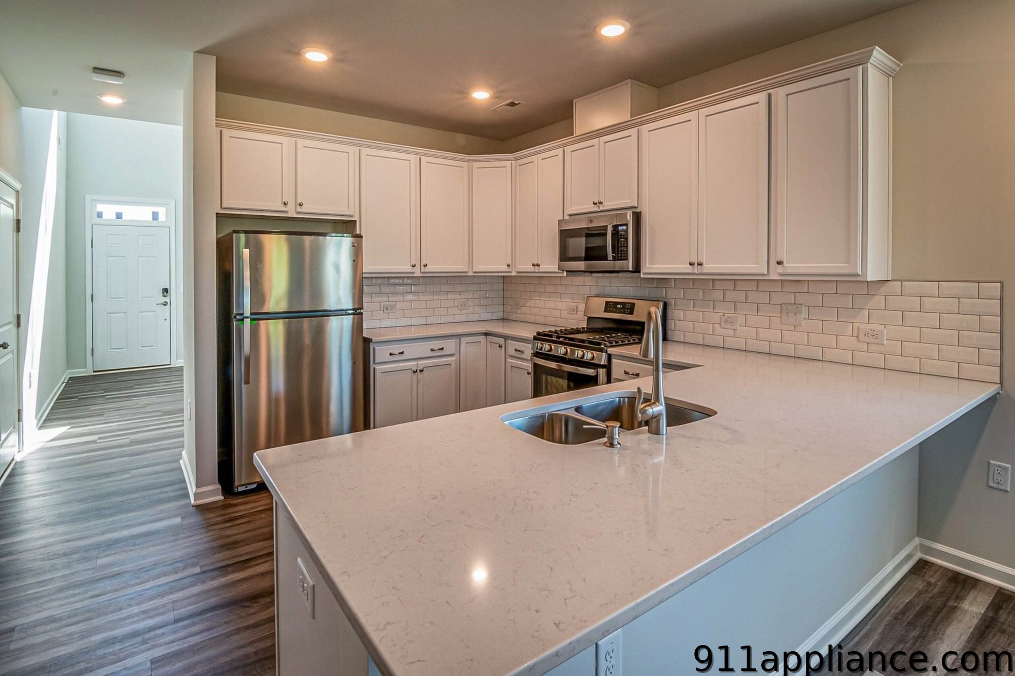Modern white kitchen with stainless steel appliances