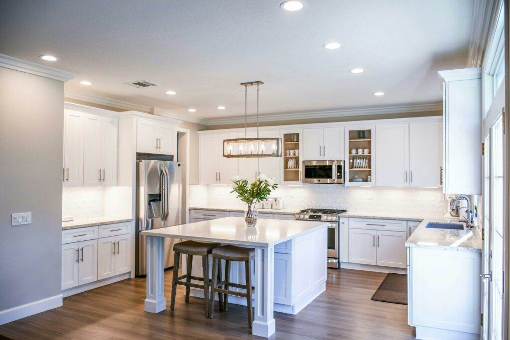 A kitchen with white cabinets and a center island.