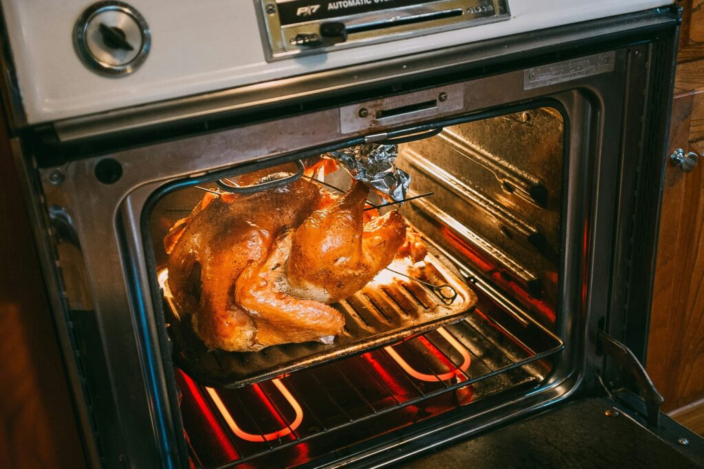 a turkey is cooking in an oven.