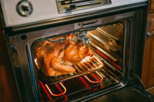 a turkey is cooking in an oven.