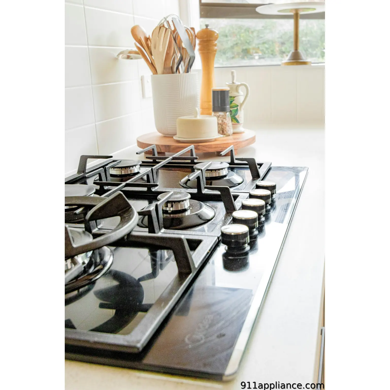 Gas stovetop with kitchen utensils
