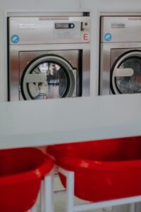 a row of washing machines in a laundry room.