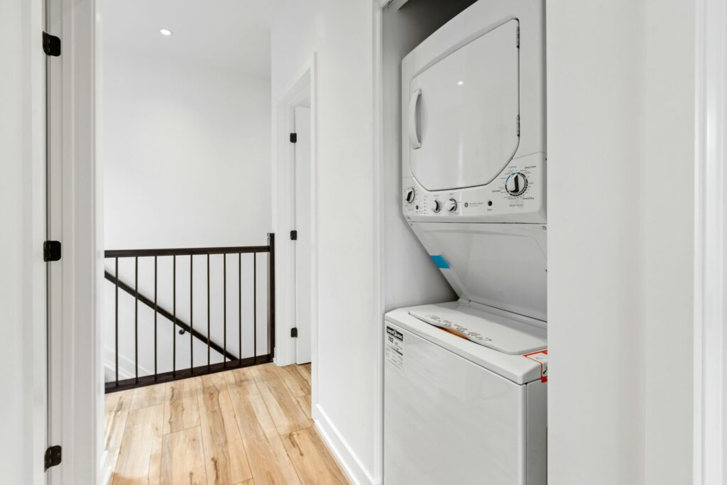 Stacked white washer dryer closet