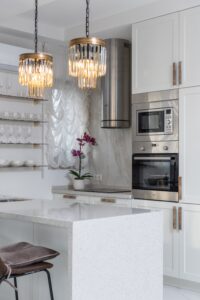 a white kitchen with a white island.