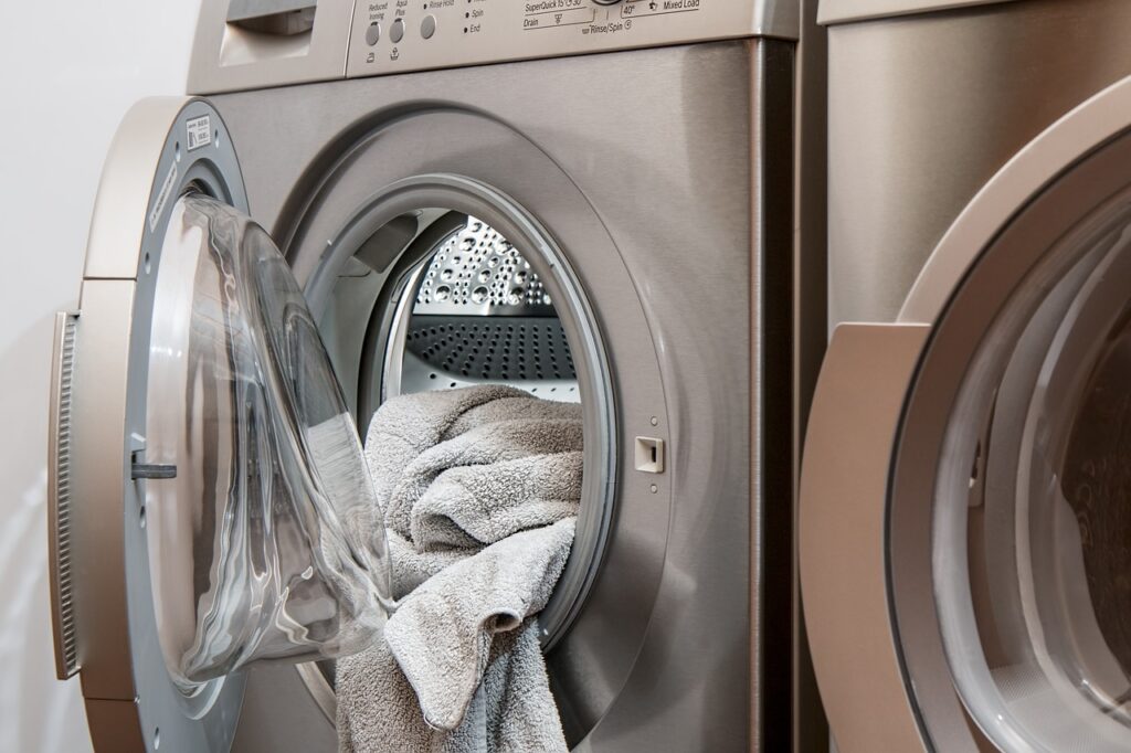 A washing machine with a towel in it.
