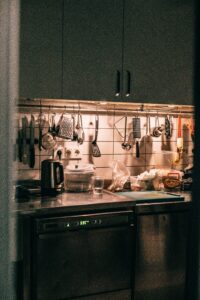 A kitchen with utensils and utensils hanging on the wall.