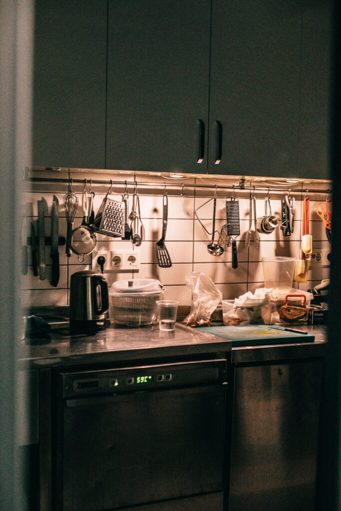 A kitchen with utensils and utensils hanging on the wall.