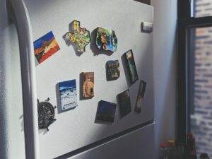 A refrigerator with a lot of magnets on it.