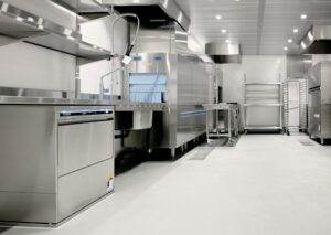 A large commercial kitchen with stainless steel appliances.