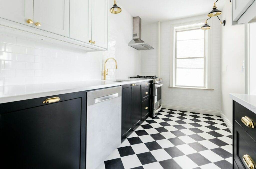 A kitchen with a black and white checkered floor.