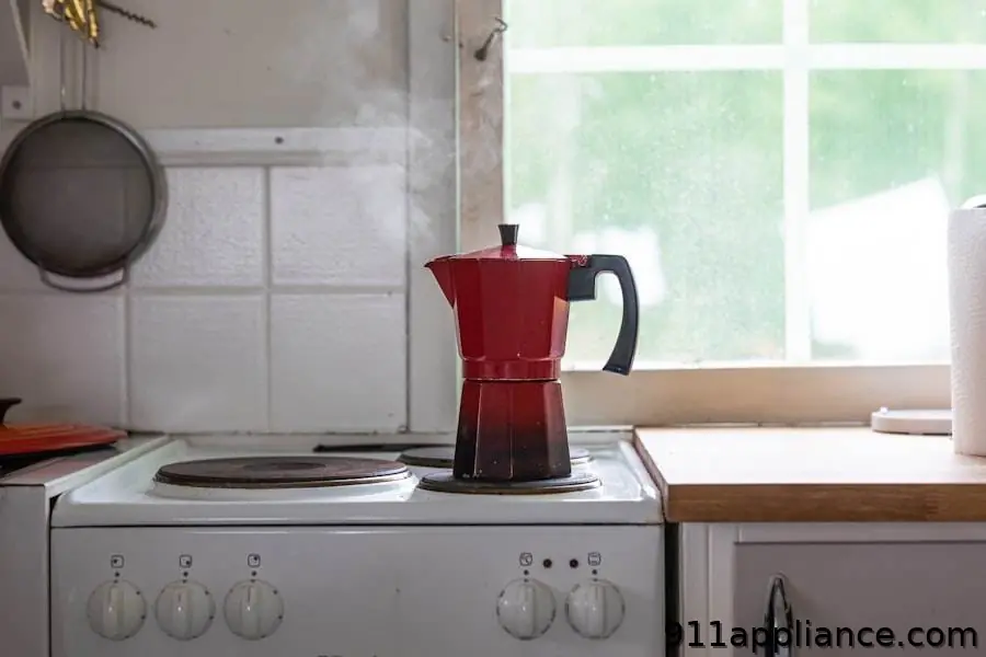 Red stovetop coffee maker steaming