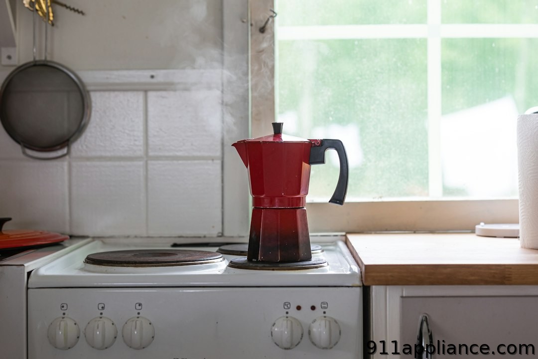 Steaming red Moka pot on stove