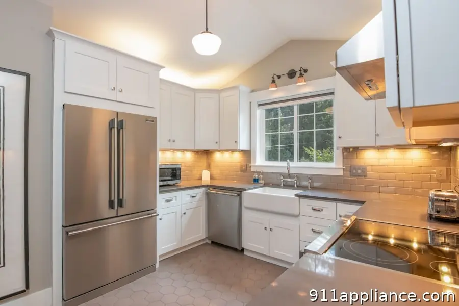 Modern white kitchen with stainless appliances