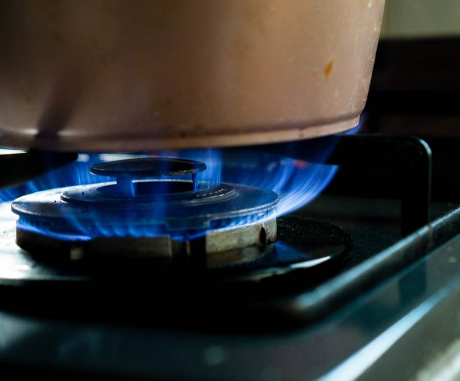 A pot on a stove with blue flames.