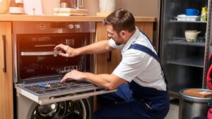 Appliance repairman fixing oven.