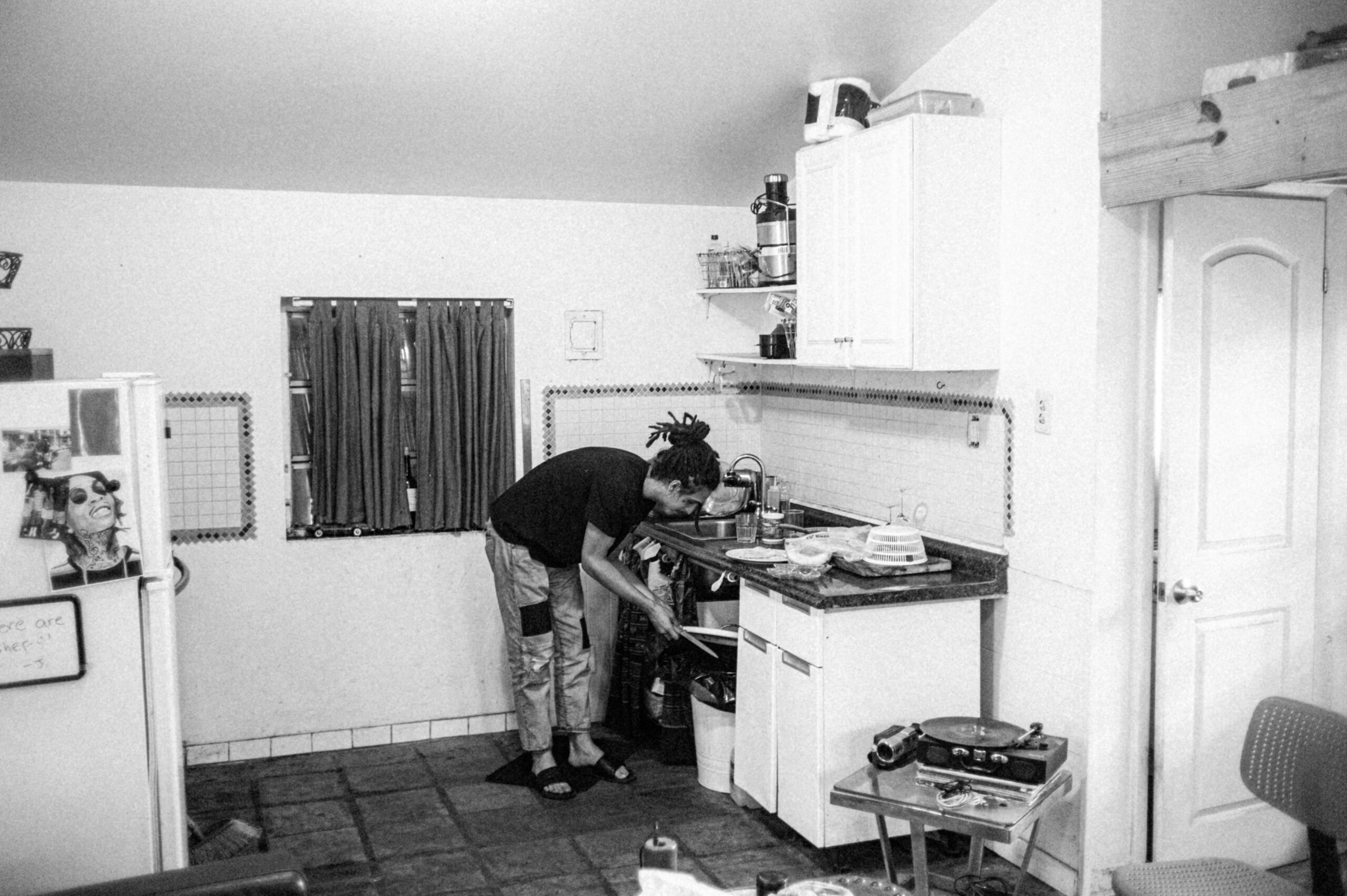 man washing dishes in kitchen